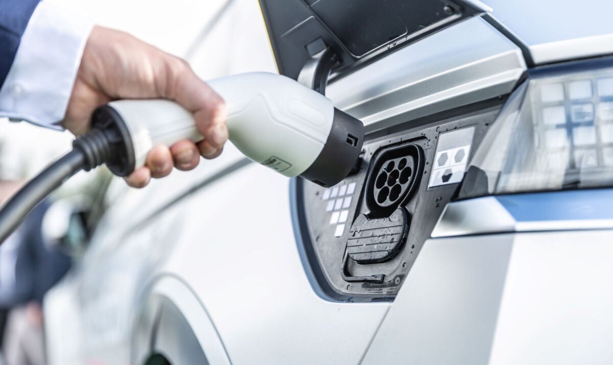 person charging an electric vehicle