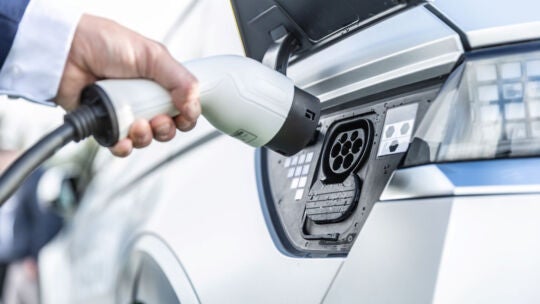 person charging an electric vehicle