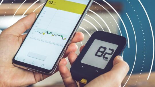 patient using a blood glucose meter