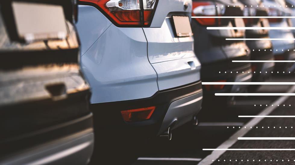 row of cars parked in a parking lot