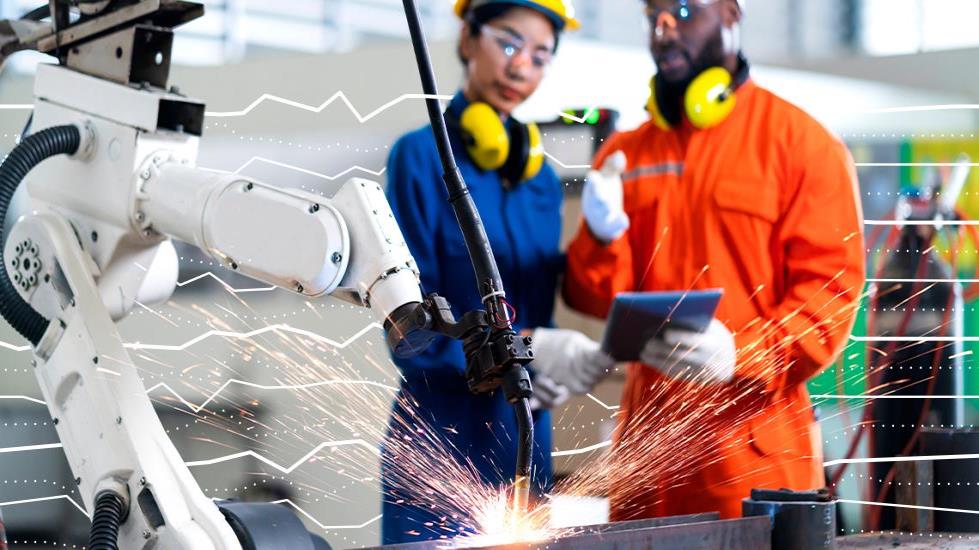 two people using robotic factory equipment