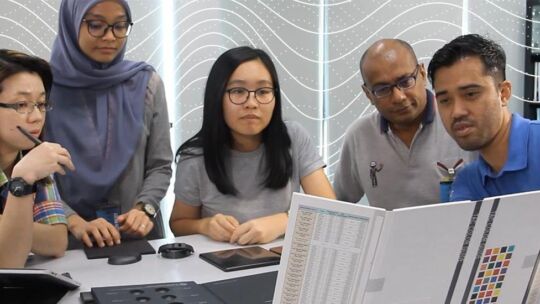 Flex employees at a table collaborating